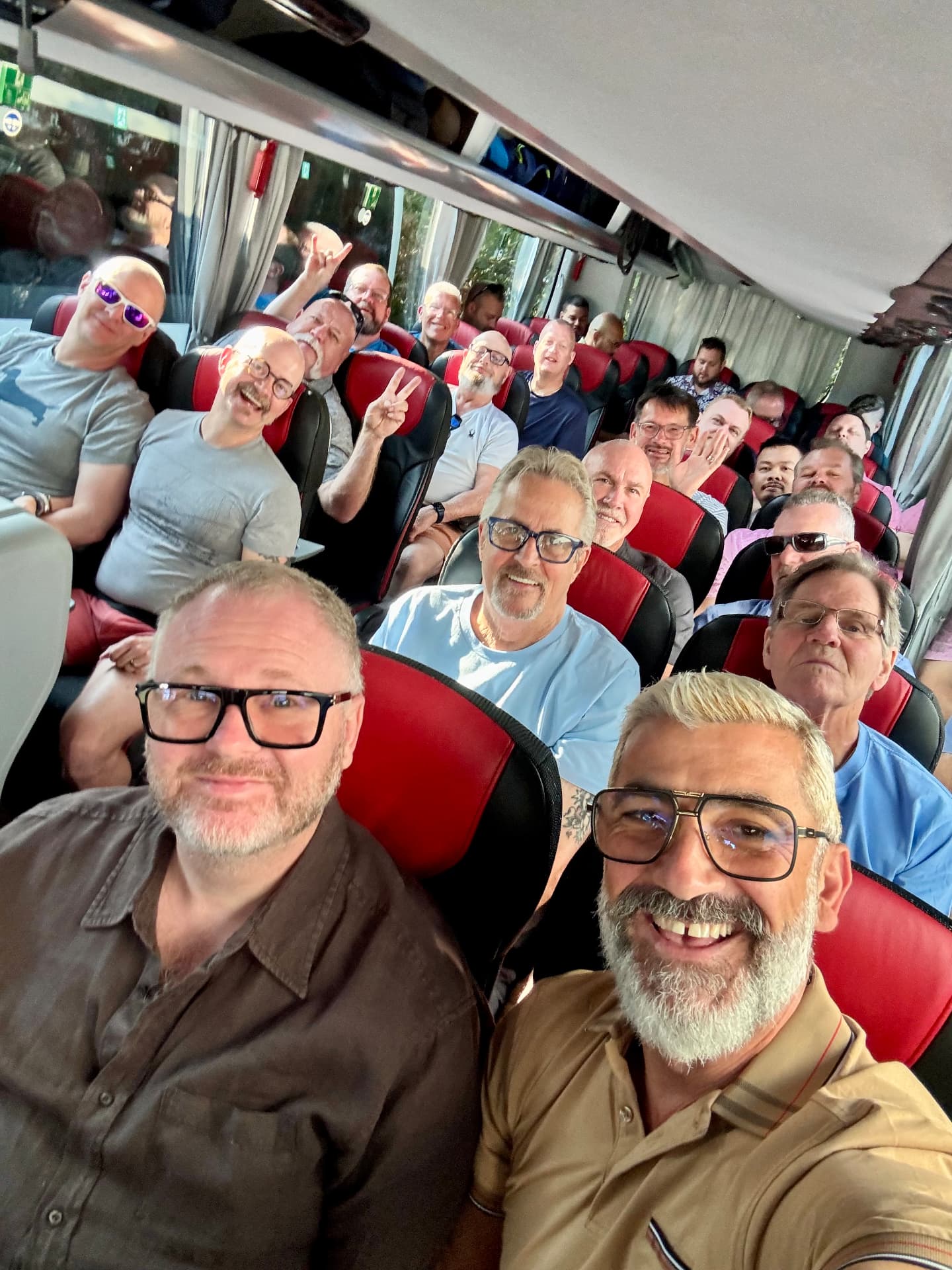 Group selfie on a coach bus during a shore excursion