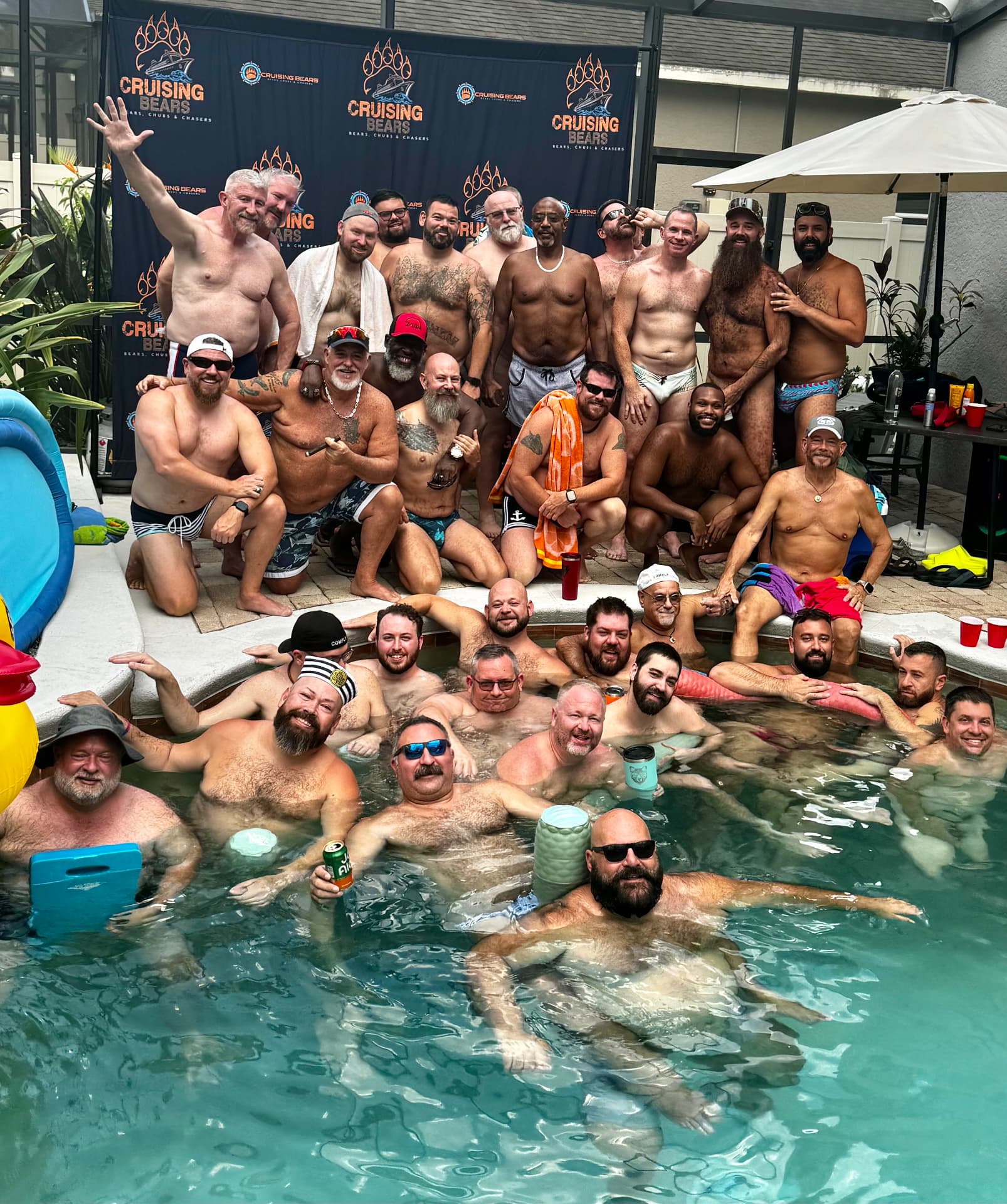 Large group pool party with CruisingBears backdrop