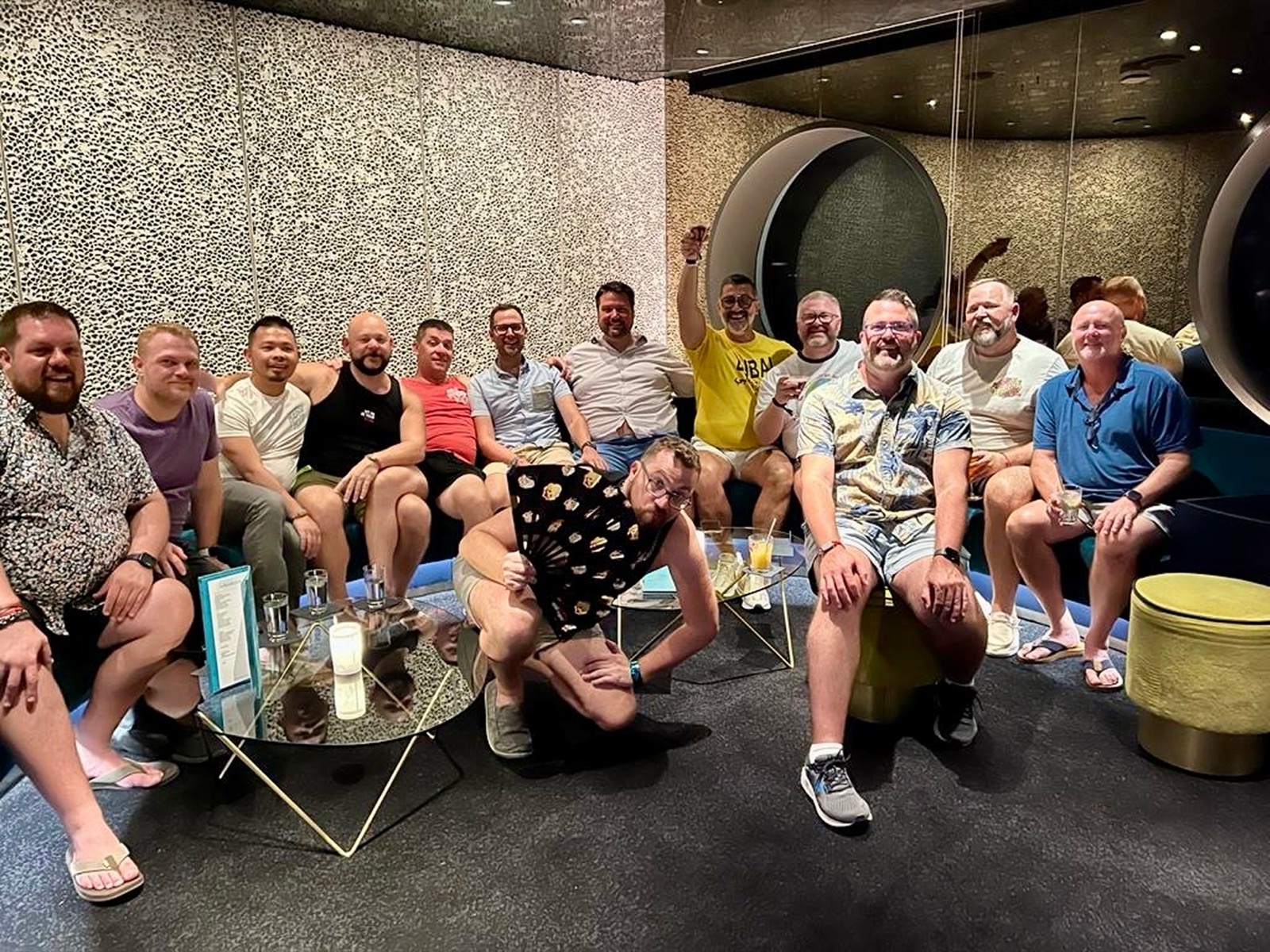 Group of men toasting in a modern lounge aboard a ship