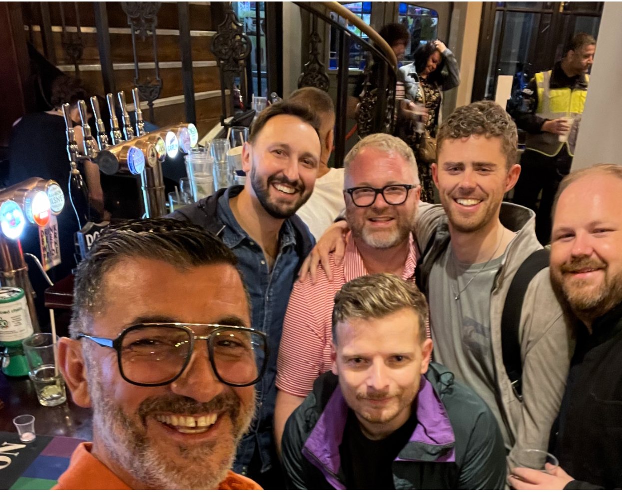 A group of bears smiling together at a bar in port