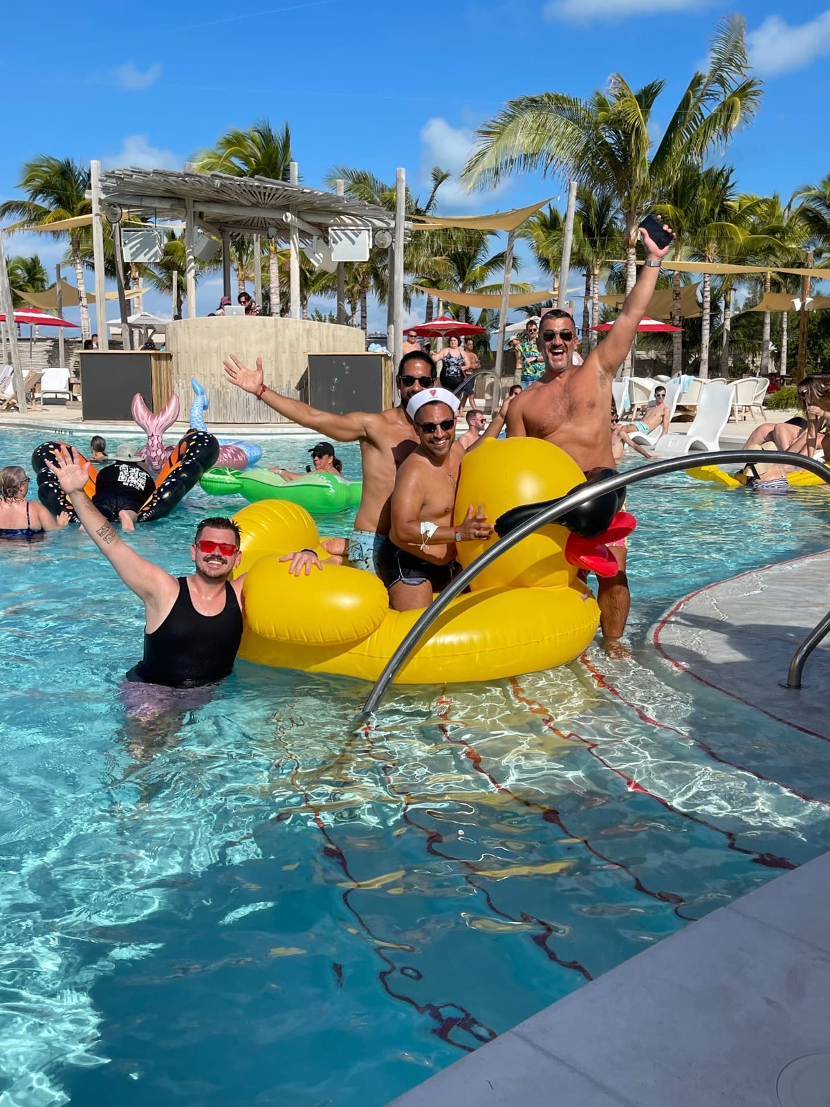 Bears in the pool with a giant inflatable rubber duck