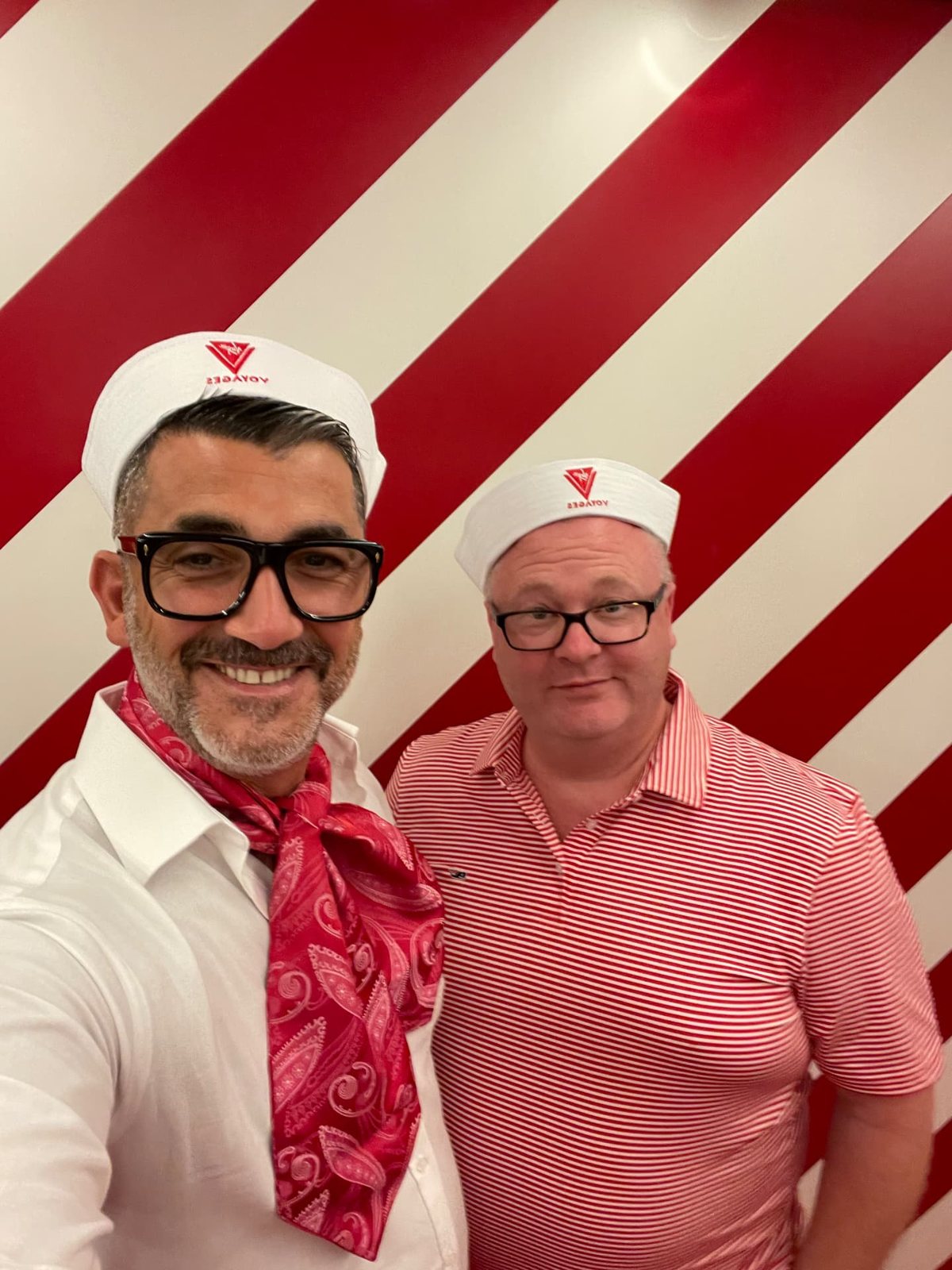 Two bears in sailor hats and red neckerchiefs on board