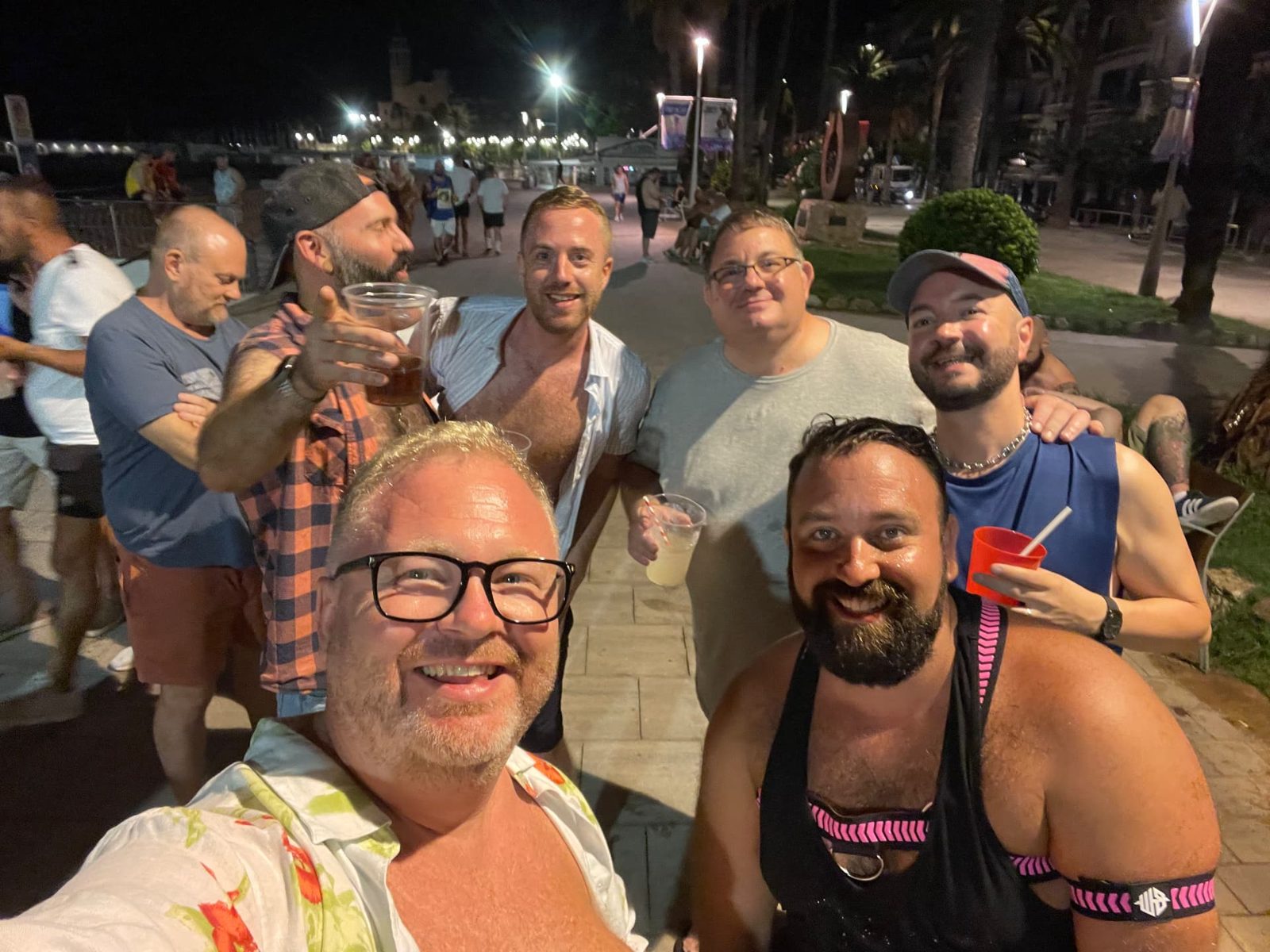 Group selfie of new friends on the Sitges promenade at night