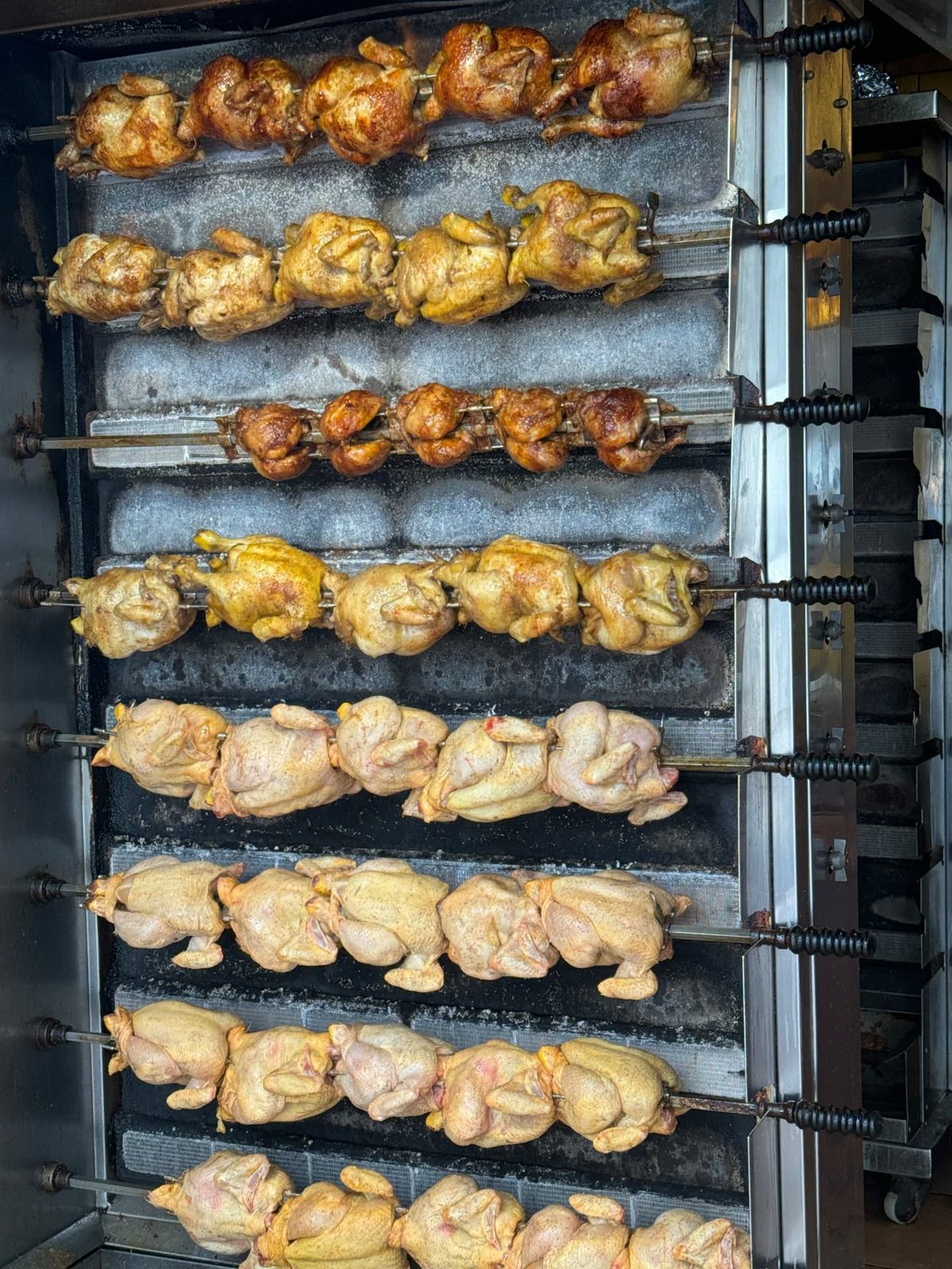Rotisserie chickens turning on the spit in Sitges