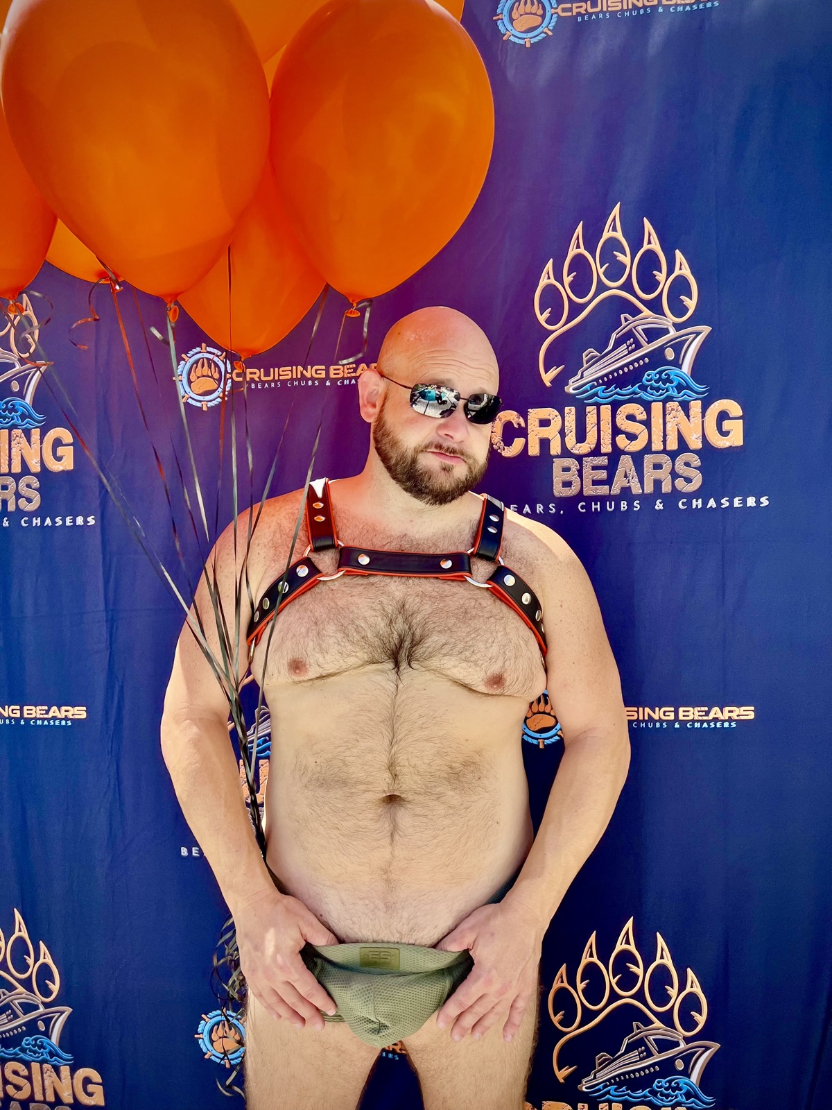 Crew member celebrating in front of the CruisingBears backdrop