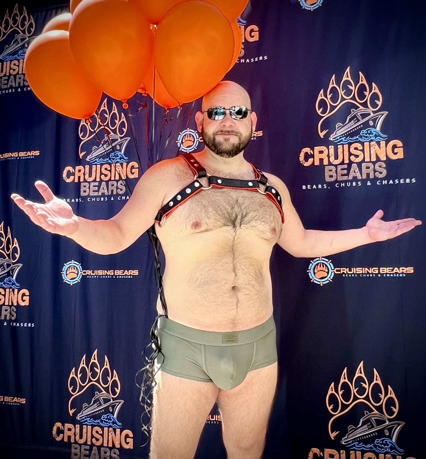 Crew member celebrating in front of the CruisingBears backdrop