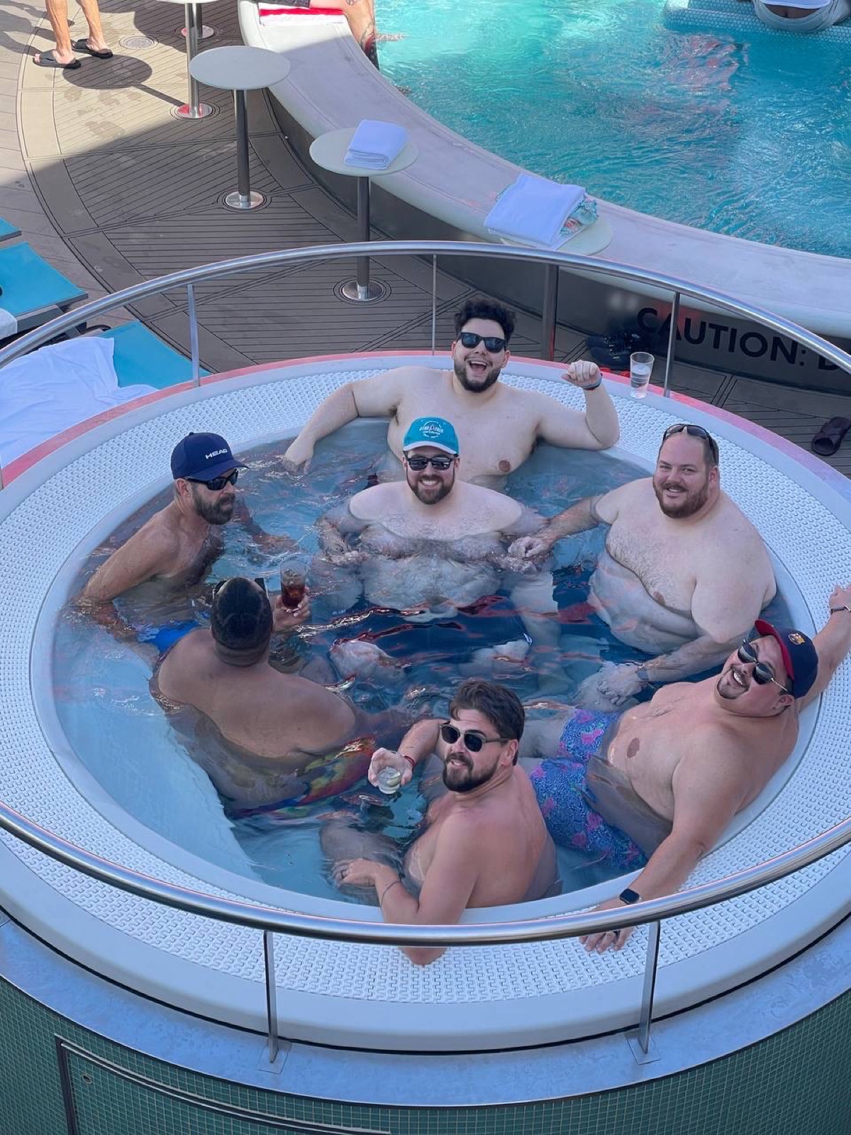 Group of friends laughing together in a cruise ship hot tub