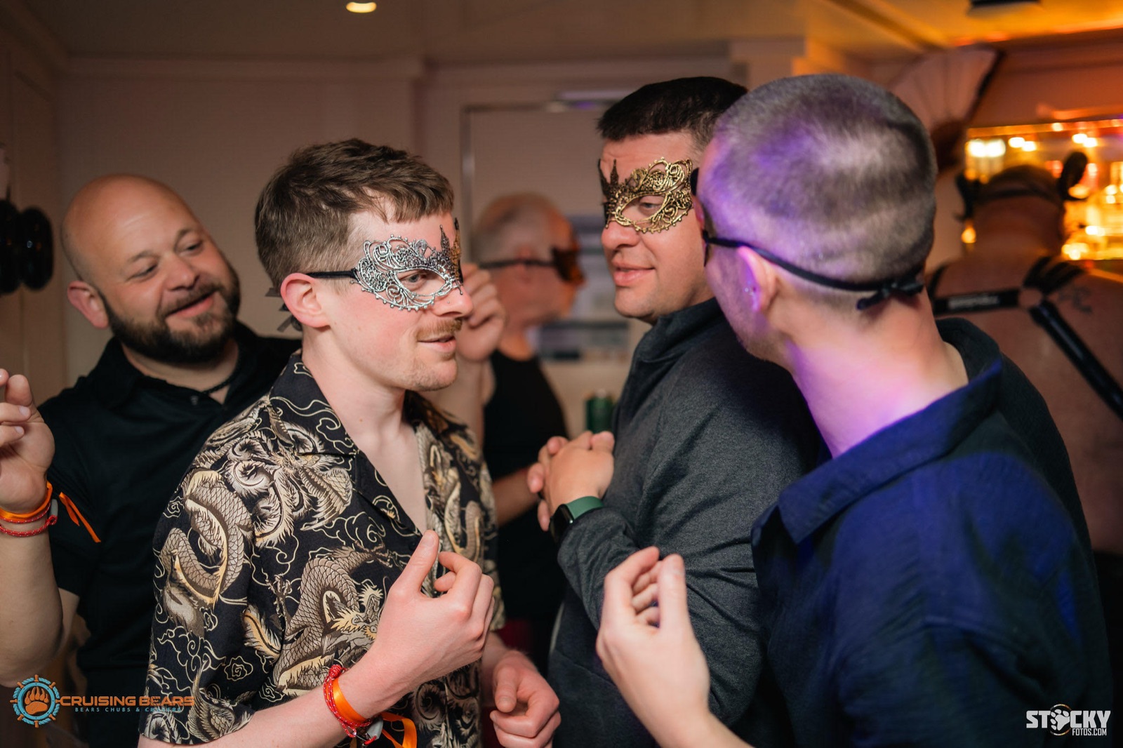 Crew members in masquerade masks at an evening event