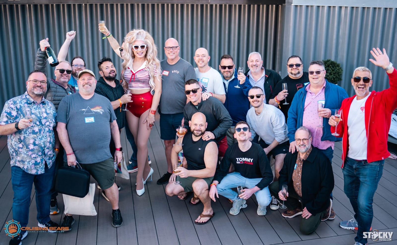 Large crew group toasting together at a rooftop gathering