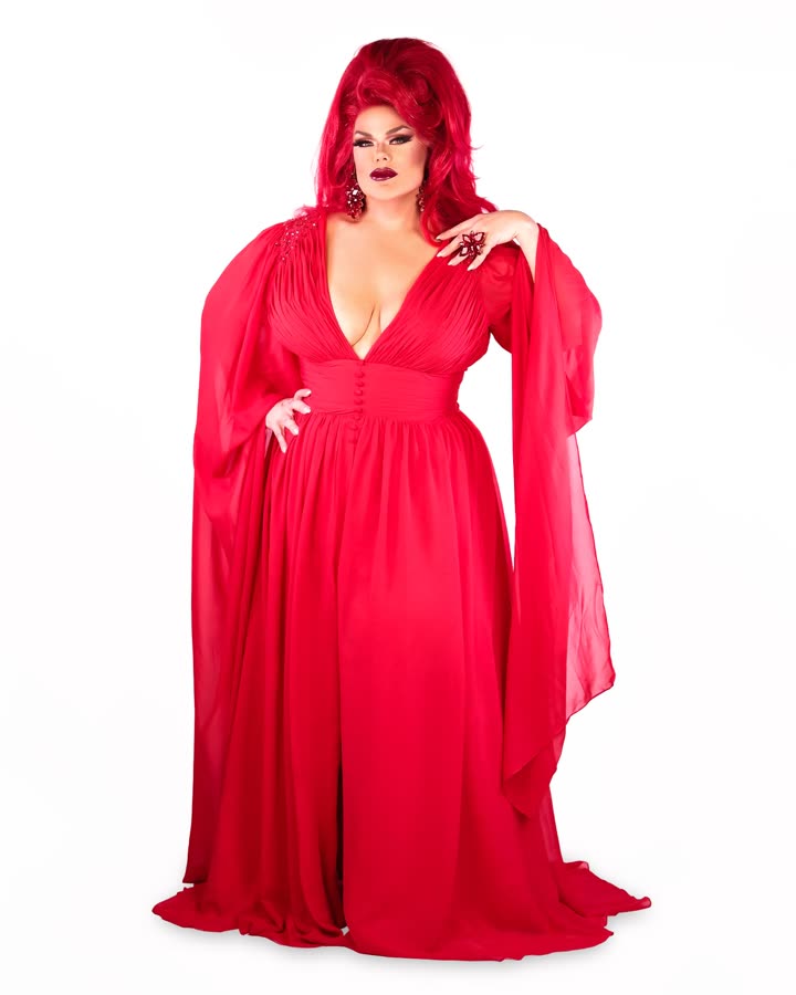 Darienne Lake in a flowing red gown with red hair