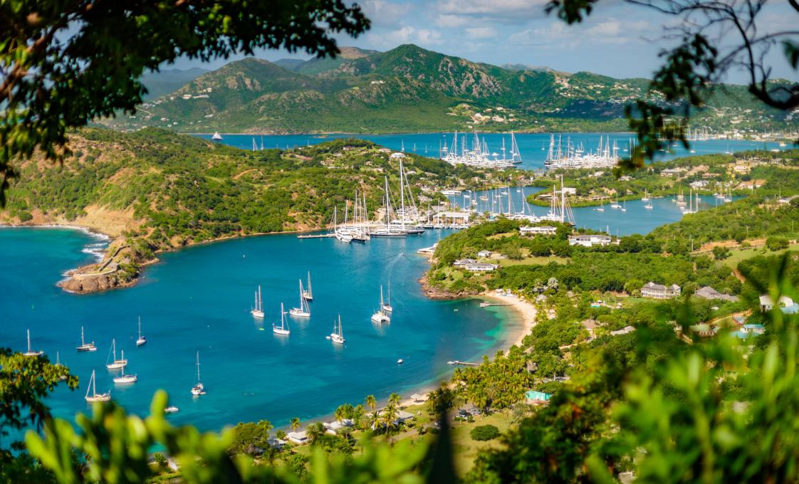Panoramic view of English Harbour, Antigua, framed by tropical greenery