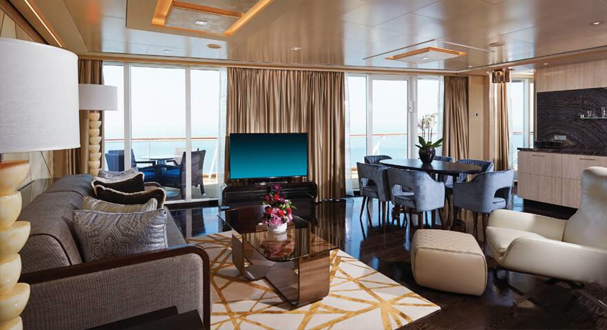 Norwegian Haven owner's suite living room with floor-to-ceiling windows, dining table and ocean view