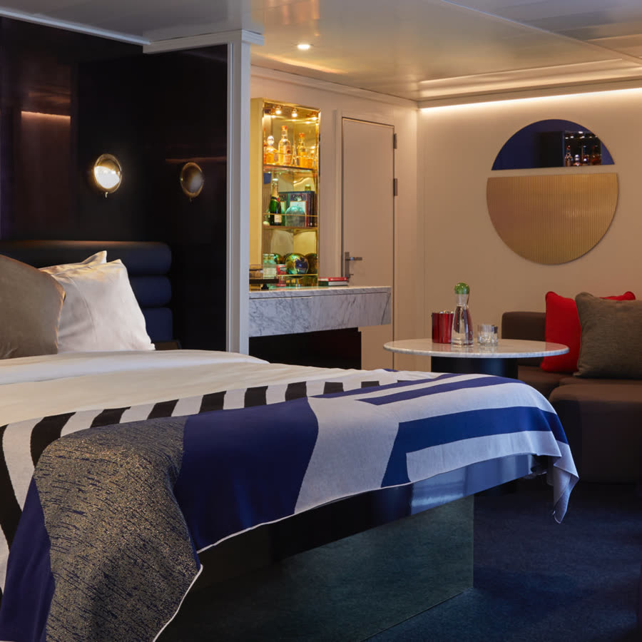 Rockstar Suite bedroom with in-room bar and lounge seating